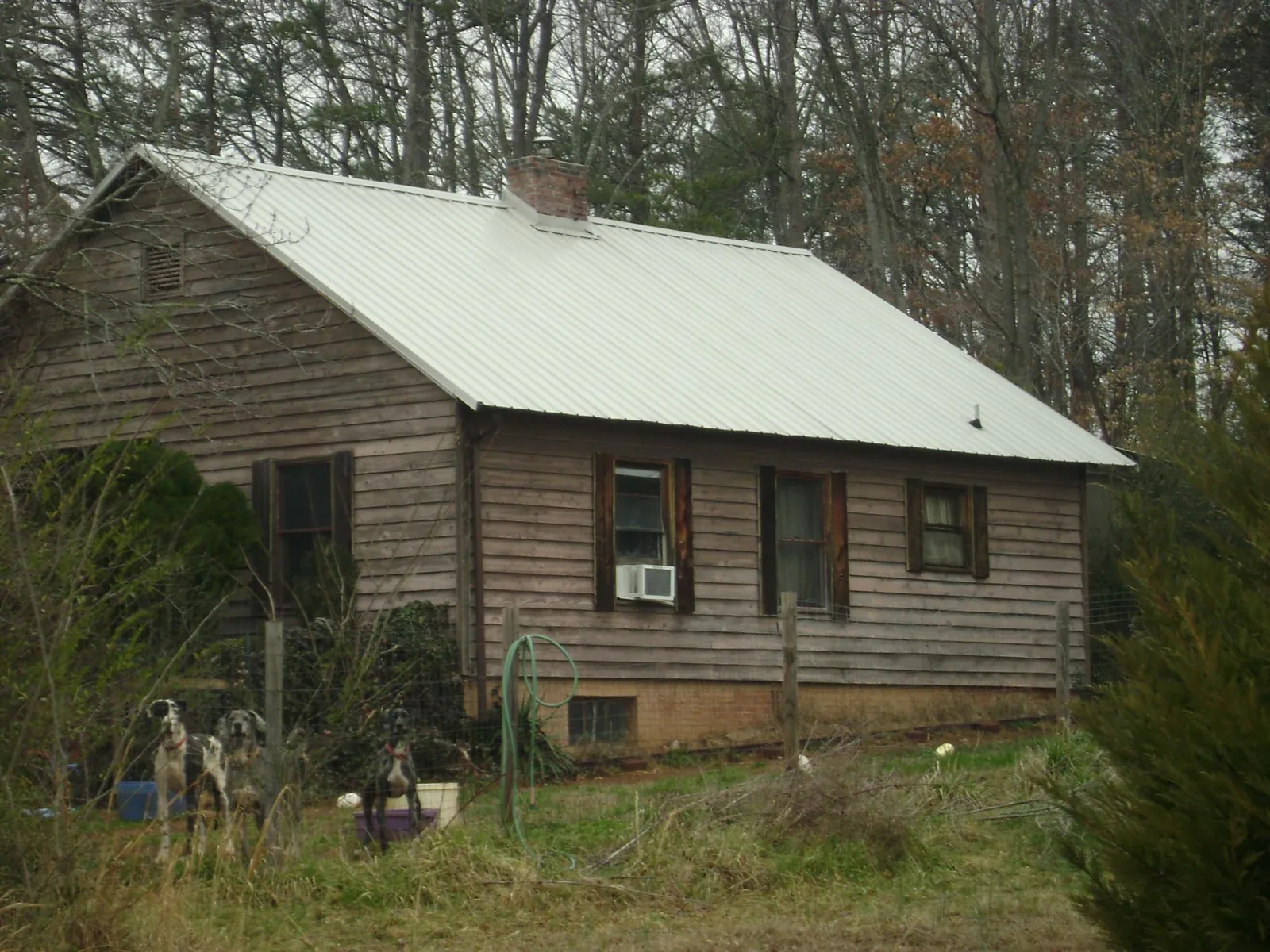 White metal roof on an old wood sided farmhouse, from a Asphalt Shingle Roof Repair job in Inwood